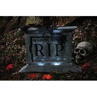 spooky tombstone with black rose